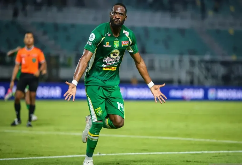 Persebaya player Yan Mabella celebrates after scoring against Madura United.